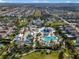 Expansive aerial shot of resort amenities including a waterpark, pool, and surrounding residential homes and landscaping at 561 Lasso Dr, Kissimmee, FL 34747