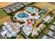 Aerial view of a resort with pools, waterslides, landscaping and residental homes surrounding the area at 561 Lasso Dr, Kissimmee, FL 34747