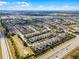 Expansive aerial view of a meticulously planned community featuring uniform homes and well-manicured landscaping under a bright blue sky at 561 Lasso Dr, Kissimmee, FL 34747