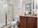 Bright bathroom with glass enclosed shower, toilet, and vanity with granite counters at 561 Lasso Dr, Kissimmee, FL 34747