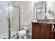 Bathroom with shower, toilet, and dark wood vanity with granite counter and attached hair dryer at 561 Lasso Dr, Kissimmee, FL 34747