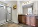 Well-lit bathroom with a glass shower, double vanity and granite countertops at 561 Lasso Dr, Kissimmee, FL 34747