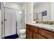 Bathroom with shower, toilet, and dark wood vanity with granite counter and blue accent rug at 561 Lasso Dr, Kissimmee, FL 34747