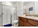 Bathroom with shower, toilet, and dark wood vanity with granite counter and blue accent rug at 561 Lasso Dr, Kissimmee, FL 34747