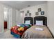 Bright bedroom featuring two twin beds with themed bedding and ensuite bathroom at 561 Lasso Dr, Kissimmee, FL 34747