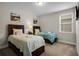 Comfortable bedroom with two twin beds, lamps, and decorative artwork at 561 Lasso Dr, Kissimmee, FL 34747