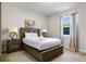 Bedroom with a queen bed, bedside lamps, a window with curtains, and simple decor at 561 Lasso Dr, Kissimmee, FL 34747