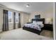 Bedroom featuring a queen bed, bedside tables, lamps and window with curtains at 561 Lasso Dr, Kissimmee, FL 34747