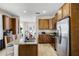Bright kitchen featuring an island with seating, stainless steel appliances, and granite countertops at 561 Lasso Dr, Kissimmee, FL 34747