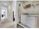 Hallway with visible laundry room featuring a washer and dryer set with wire shelving for storage at 561 Lasso Dr, Kissimmee, FL 34747