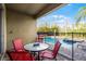 Cozy patio with red seating overlooking a sparkling pool and lush landscaping at 561 Lasso Dr, Kissimmee, FL 34747