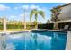 Inviting in-ground pool is surrounded by lush greenery at 561 Lasso Dr, Kissimmee, FL 34747