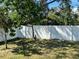 Backyard featuring a white fence and greenery, creating a private outdoor space at 608 S Lakeview Ave, Winter Garden, FL 34787