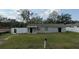 Single-story house with a gray exterior, dark roof, large yard and a surrounding fence at 608 S Lakeview Ave, Winter Garden, FL 34787