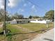 Wide view of the home and large front yard showing the exterior facade and white fencing at 608 S Lakeview Ave, Winter Garden, FL 34787