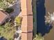Enjoy aerial views of the condo complex featuring a terracotta roof with a fountain water feature at 6109 Metrowest Blvd # 105, Orlando, FL 32835