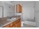 Bathroom featuring a vanity, sink, toilet, and a shower-tub combination at 6109 Metrowest Blvd # 105, Orlando, FL 32835