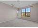 Inviting bedroom featuring a large window with views and comfortable carpeting at 6109 Metrowest Blvd # 105, Orlando, FL 32835