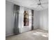 Bright bedroom with large window, neutral carpet, and elegant window treatments at 6109 Metrowest Blvd # 105, Orlando, FL 32835