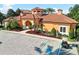 The clubhouse features a Spanish tile roof, manicured landscaping, and convenient parking in a welcoming community setting at 6109 Metrowest Blvd # 105, Orlando, FL 32835