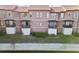 Beautiful townhomes feature stucco exteriors, tile roofs, and private balconies overlooking the scenic waterfront at 6109 Metrowest Blvd # 105, Orlando, FL 32835