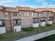 View of the Mediterranean-style condo complex featuring private balconies and terracotta tiled roofs at 6109 Metrowest Blvd # 105, Orlando, FL 32835