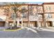 Beautiful townhome exterior with private garages and stone accents at 6109 Metrowest Blvd # 105, Orlando, FL 32835