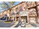 An exterior view of townhomes showcasing the architectural details and attached garages at 6109 Metrowest Blvd # 105, Orlando, FL 32835