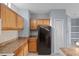 Kitchen with wood cabinets and black appliances at 6109 Metrowest Blvd # 105, Orlando, FL 32835