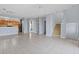 Bright living room featuring tile flooring, a staircase, and neutral wall paint at 6109 Metrowest Blvd # 105, Orlando, FL 32835
