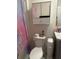 Bathroom with a toilet, vanity, and mirror-doored medicine cabinet above the toilet at 735 Chinoy Rd, Davenport, FL 33837
