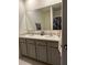 Bright bathroom featuring a double sink vanity with granite countertops and a large mirror at 735 Chinoy Rd, Davenport, FL 33837
