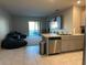 Bright living room featuring tile floors, a ceiling fan, and a sliding glass door at 735 Chinoy Rd, Davenport, FL 33837