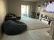 Spacious living room with a large sectional sofa, comfortable seating, and a sliding glass door at 735 Chinoy Rd, Davenport, FL 33837