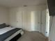 Neutral main bedroom features two closets and space for a television at 735 Chinoy Rd, Davenport, FL 33837