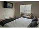 Bright primary bedroom with a window, television, and queen size bed at 735 Chinoy Rd, Davenport, FL 33837