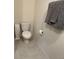 Toilet in a neutral-colored bathroom with gray towels at 735 Chinoy Rd, Davenport, FL 33837