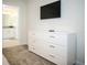 Bedroom featuring a dresser and a door leading into the bathroom at 750 Pebble Beach Dr, Davenport, FL 33896