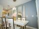 Dining area with modern pendant lights, mirrors, and decor at 750 Pebble Beach Dr, Davenport, FL 33896