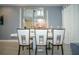 Dining room boasts seating for six, bright natural light, and modern decor at 750 Pebble Beach Dr, Davenport, FL 33896