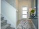 Inviting foyer with a stylish console table and staircase at 750 Pebble Beach Dr, Davenport, FL 33896