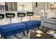 Open-concept living area featuring a breakfast bar, sofa, and modern furnishings at 750 Pebble Beach Dr, Davenport, FL 33896