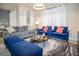 Comfortable living room with a gray sofa, blue chairs, modern lighting and a stylish rug at 750 Pebble Beach Dr, Davenport, FL 33896