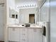 Bathroom features a double vanity with a large framed mirror and a glass-enclosed shower at 802 Brunello Dr, Davenport, FL 33897