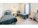 Comfortable bedroom with twin beds, soft lighting, and a serene atmosphere at 802 Brunello Dr, Davenport, FL 33897