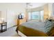 Comfortable bedroom features a large window, ceiling fan, and a TV atop a wooden dresser at 802 Brunello Dr, Davenport, FL 33897
