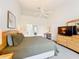 Light and airy bedroom features a ceiling fan and access to both closets and the en suite bath at 802 Brunello Dr, Davenport, FL 33897