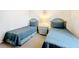 Comfortable bedroom featuring twin beds with elegant details, creating a peaceful retreat at 802 Brunello Dr, Davenport, FL 33897