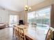Dining area with a view of the screened patio and pool, perfect for indoor-outdoor living at 802 Brunello Dr, Davenport, FL 33897