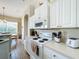 Well-equipped kitchen with white cabinets and modern appliances, offering both style and efficiency at 802 Brunello Dr, Davenport, FL 33897